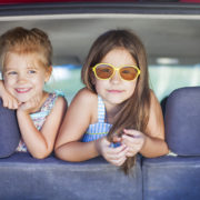 Happy kids in the car. Family on vacation. Summer holiday and car travel concept