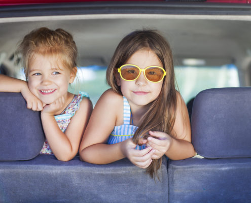 Happy kids in the car. Family on vacation. Summer holiday and car travel concept